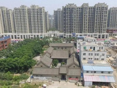 ​高楼包围中的一座古宅，主人多少钱都不卖，它到底有什么来历呢？